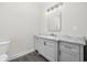 Bathroom featuring gray vanity with marble countertop, mirror, lighting, and toilet at 627 Bonaventure Dr. # 204, Myrtle Beach, SC 29577