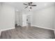 Spacious bedroom with hardwood floors, a modern ceiling fan, and multiple doorways at 627 Bonaventure Dr. # 204, Myrtle Beach, SC 29577