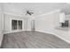 Open concept living room with gray wood flooring, a ceiling fan, and access to the patio at 627 Bonaventure Dr. # 204, Myrtle Beach, SC 29577