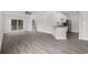 Bright and airy living area featuring gray wood flooring, a ceiling fan, and open access to the kitchen at 627 Bonaventure Dr. # 204, Myrtle Beach, SC 29577