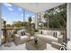 Cozy screened porch with wicker furniture, a glass-topped coffee table, and a view of the neighborhood at 627 Bonaventure Dr. # 204, Myrtle Beach, SC 29577