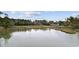 Scenic waterfront view with lush green vegetation and dock at 627 Bonaventure Dr. # 204, Myrtle Beach, SC 29577
