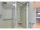 Bright bathroom featuring a glass enclosed shower with tile surround, grab bar and shower seat at 647 Norris Dr., Pawleys Island, SC 29585