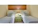 Comfortable bedroom showcasing twin beds with bright lamps and window with wood blinds at 647 Norris Dr., Pawleys Island, SC 29585