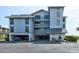 Beach condo building with parking garage and multiple balconies overlooking the coast at 647 Norris Dr., Pawleys Island, SC 29585