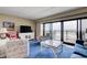 Living room with ocean view, coastal decor, and balcony access in a cozy, inviting space at 647 Norris Dr., Pawleys Island, SC 29585