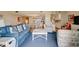 Open-concept living room featuring hardwood floors, a comfortable blue sofa, and coastal decor that connects to a kitchen at 647 Norris Dr., Pawleys Island, SC 29585