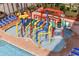 Colorful water park area near a pool featuring slides, buckets, and water features for Gathering fun at 6900 N Ocean Blvd. # 404, Myrtle Beach, SC 29572