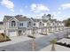 View of newly constructed townhomes showcasing colorful facades, garages and well-manicured landscaping in a friendly community at 904 62Nd Ave. N # A, Myrtle Beach, SC 29572