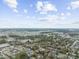 Expansive aerial view of residential area featuring lush green spaces and serene pond at 904 62Nd Ave. N # E, Myrtle Beach, SC 29572