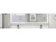 Bathroom featuring double sinks, vanity, an illuminated mirror, and modern fixtures at 904 62Nd Ave. N # E, Myrtle Beach, SC 29572