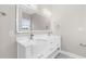 Bathroom featuring double sinks with vanity, illuminated mirror, and modern fixtures at 904 62Nd Ave. N # E, Myrtle Beach, SC 29572