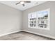 Bright, neutral bedroom with a large window offering neighborhood views and wood-look flooring at 904 62Nd Ave. N # E, Myrtle Beach, SC 29572