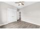 This bedroom has a ceiling fan, neutral paint, wood-look floors, and double door closet at 904 62Nd Ave. N # E, Myrtle Beach, SC 29572