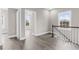 Spacious hallway showcasing wood-look floors, natural light from large windows, and white trim at 904 62Nd Ave. N # E, Myrtle Beach, SC 29572