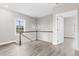 Upstairs landing with wood-look floors, wood and white banister, and a pendant light at 904 62Nd Ave. N # E, Myrtle Beach, SC 29572