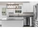 Bright kitchen featuring granite countertops, stainless steel appliances, island, and modern lighting at 904 62Nd Ave. N # E, Myrtle Beach, SC 29572