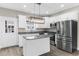 Modern kitchen features an island, stainless steel appliances, and white cabinets with granite countertops at 904 62Nd Ave. N # E, Myrtle Beach, SC 29572