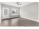 Bright, airy living room showcasing wood-look floors, a ceiling fan, and a large window with outside views at 904 62Nd Ave. N # E, Myrtle Beach, SC 29572