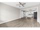 Open living space with luxury vinyl plank flooring, transitioning to the kitchen and staircase at 904 62Nd Ave. N # E, Myrtle Beach, SC 29572