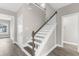 Stairway with wood and white railing, leading upstairs with views of an adjacent room at 904 62Nd Ave. N # E, Myrtle Beach, SC 29572