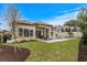 Landscaped backyard features a pool, patio area, and well-maintained lawn for outdoor enjoyment at 9109 Sanremo Ln., Myrtle Beach, SC 29579
