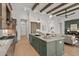 Open kitchen features an island, pendant lighting, stainless steel appliances, and seamless access to the living room at 9109 Sanremo Ln., Myrtle Beach, SC 29579