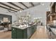 Open-concept kitchen with a central island, wood beams, and stainless steel appliances at 9109 Sanremo Ln., Myrtle Beach, SC 29579
