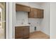 Functional laundry room featuring custom cabinets, a utility sink, and plenty of storage space at 9109 Sanremo Ln., Myrtle Beach, SC 29579