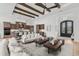Inviting living room features wood beams, comfortable seating, and seamless transition to kitchen and entry at 9109 Sanremo Ln., Myrtle Beach, SC 29579