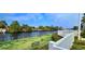 Scenic view from condo backyard featuring a black metal bench overlooking a serene river at 1100 Commons Blvd. # 606, Myrtle Beach, SC 29572