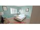 This is a simple bedroom with a bed, window, and decor with a green wall at 1100 Commons Blvd. # 606, Myrtle Beach, SC 29572