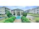 A gazebo sits in the middle of a pond in a condo community, surrounded by manicured shrubs and greenery at 1100 Commons Blvd. # 606, Myrtle Beach, SC 29572
