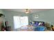 Relaxing living room features a comfortable blue sofa and ample natural light from the balcony with green walls at 1100 Commons Blvd. # 606, Myrtle Beach, SC 29572