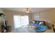 Relaxing living room features a comfortable blue sofa and ample natural light from the balcony at 1100 Commons Blvd. # 606, Myrtle Beach, SC 29572