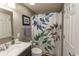 Well-lit bathroom featuring a patterned shower curtain and updated fixtures at 1221 Tidewater Dr. # 1922, North Myrtle Beach, SC 29582