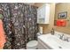 Full bathroom with vanity and floral shower curtain at 1221 Tidewater Dr. # 1922, North Myrtle Beach, SC 29582