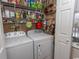 Functional laundry room with appliances, storage shelves, and natural light from a nearby window at 1221 Tidewater Dr. # 1922, North Myrtle Beach, SC 29582