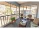 Comfortable screened porch with wicker seating and a glass table, perfect for enjoying the scenery at 1221 Tidewater Dr. # 1922, North Myrtle Beach, SC 29582