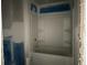 A bathroom featuring a bathtub with white tile surround and convenient shelving at 1274 Pinetucky Dr., Galivants Ferry, SC 29544