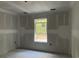 A bedroom with drywall installed features a window and bare concrete floors at 1274 Pinetucky Dr., Galivants Ferry, SC 29544
