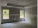 The main bedroom is being built with a tray ceiling, two windows, and bare drywall at 1274 Pinetucky Dr., Galivants Ferry, SC 29544