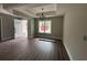 Open living room with wood floors and modern lighting fixtures at 1274 Pinetucky Dr., Galivants Ferry, SC 29544