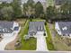 Aerial view of a landscaped home with a long driveway and mature trees at 129 Astoria Park Loop, Conway, SC 29526