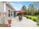 Expansive back patio perfect for outdoor dining, featuring an outdoor dining set and lush landscaping at 129 Astoria Park Loop, Conway, SC 29526