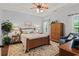 Comfortable bedroom features a ceiling fan, a wooden bed frame, and neutral tones at 129 Astoria Park Loop, Conway, SC 29526