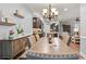 Open dining area with chandelier lighting adjacent to a kitchen and doorway at 129 Astoria Park Loop, Conway, SC 29526