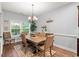 Dining area with large windows and chandelier lighting perfect for Gathering gatherings at 129 Astoria Park Loop, Conway, SC 29526