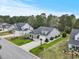 Beautiful landscaped home featuring manicured lawn, palm trees and a covered entrance at 129 Astoria Park Loop, Conway, SC 29526
