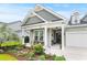 Charming single-story home featuring a covered front porch and manicured landscaping at 129 Astoria Park Loop, Conway, SC 29526